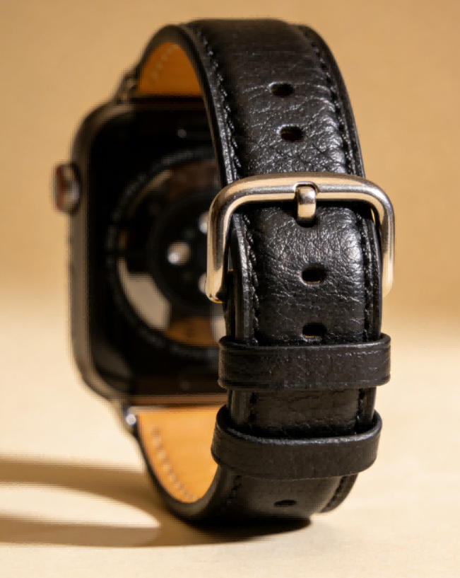 Brown leather-like watch strap with buckle and punched holes