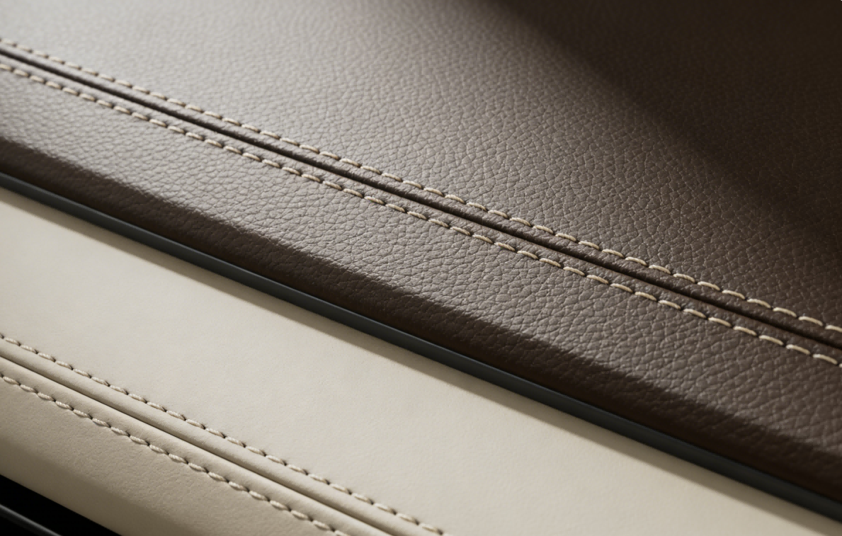 Stitched seams on brown and pale leather-like material samples