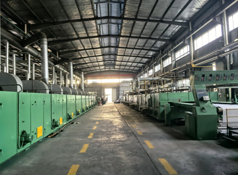 Factory aisle lined with continuous industrial processing equipment