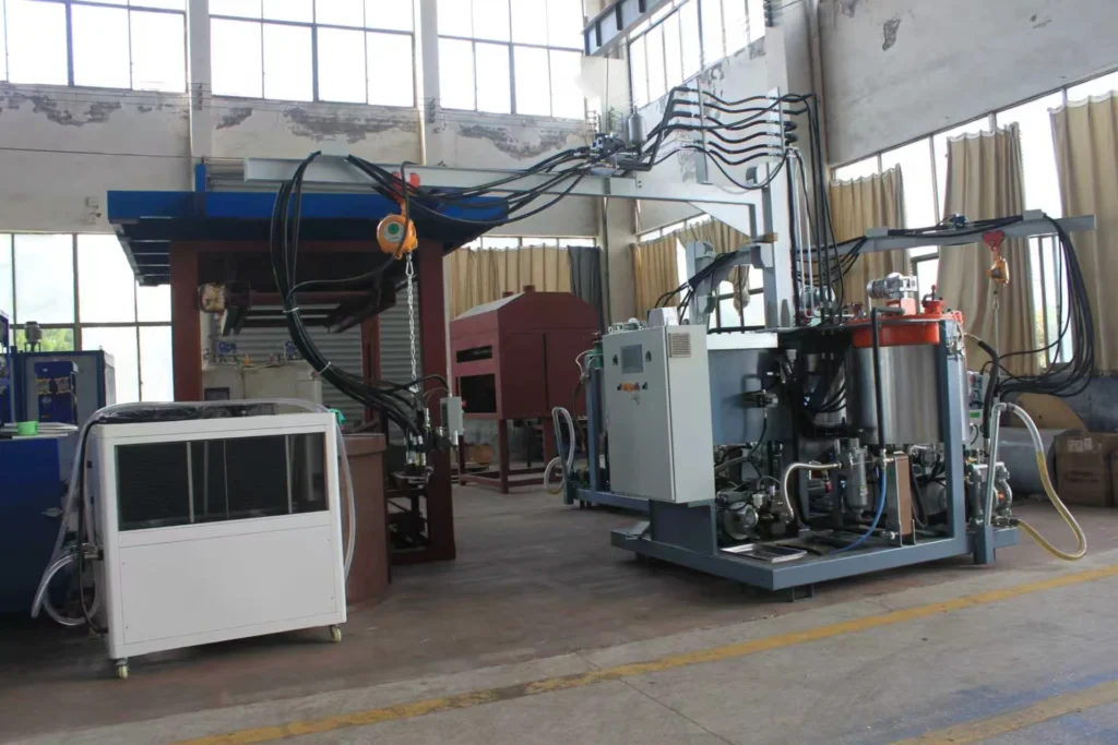 High-pressure polyurethane foaming machine and suspended mixing heads in a sandwich panel equipment workshop